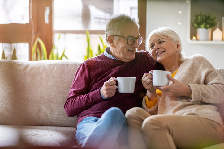 Smiling couple sitting on a couch