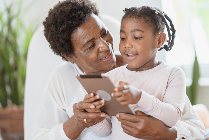 Elderly woman holding her grandchild